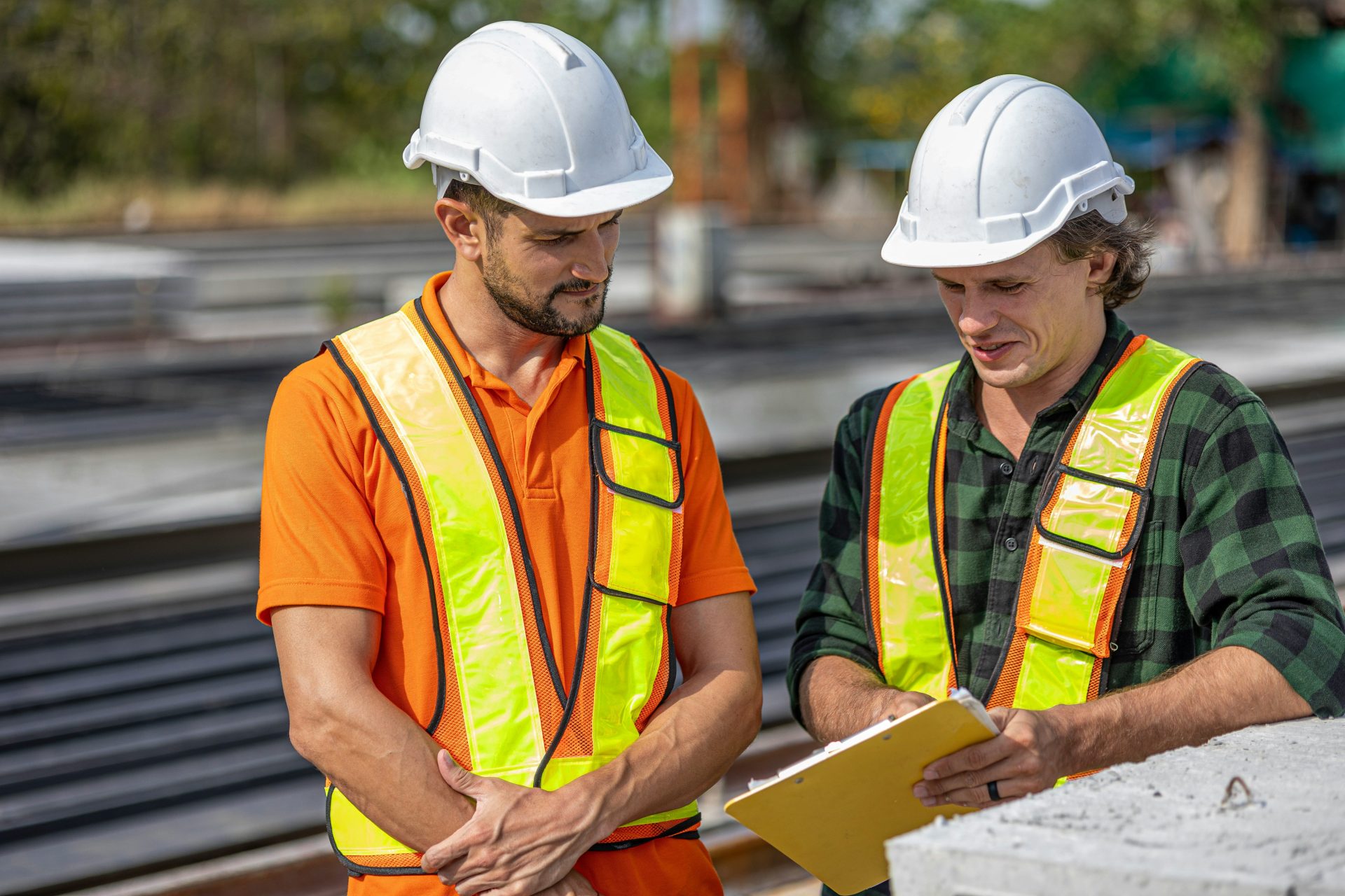 Construction workers review plans at a job site